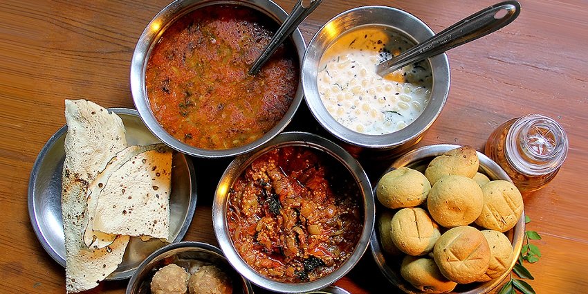 A table filled with authentic Rajithani food, served at a restaurant nearby