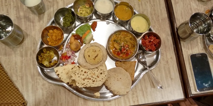 Special thali from Madhya Pradesh with a variety of traditional dishes and accompaniments.