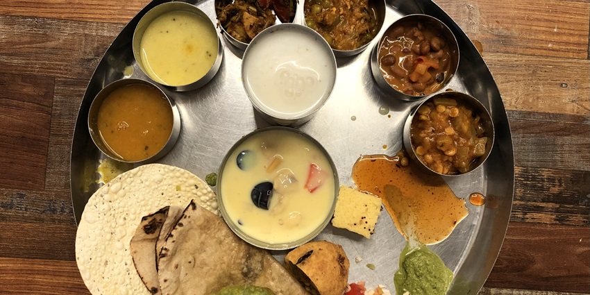 Savour a traditional Rajasthani thali near Desert National Park offering a variety of local dishes.