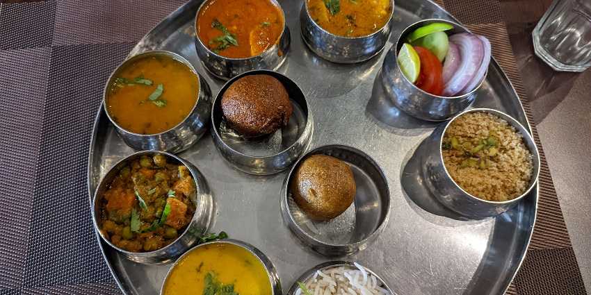 A traditional Rajasthani thali near Sariska National Park, offering a variety of local delicacies.