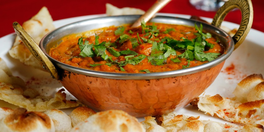 A plate of delicious Indian curry with naan served at a restaurant in Chandigarh