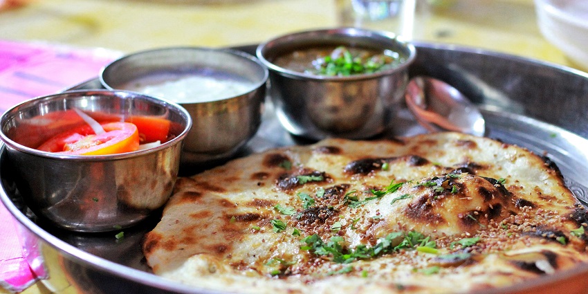Snap of the mouthwatering traditional Amritsari Chole Kulche in a platter in a Restaurant