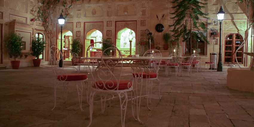  Night view of the inner courtyard of Samode Palace, showcasing its architectural details.