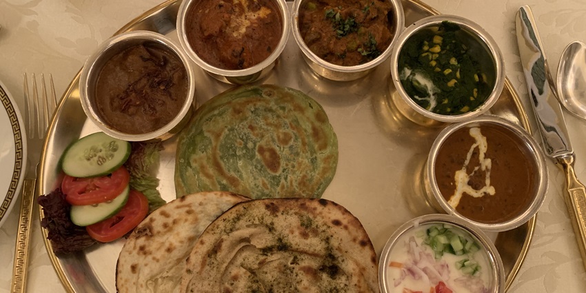 An elaborate Royal Rajasthani thali featuring a variety of traditional Rajasthani dishes.