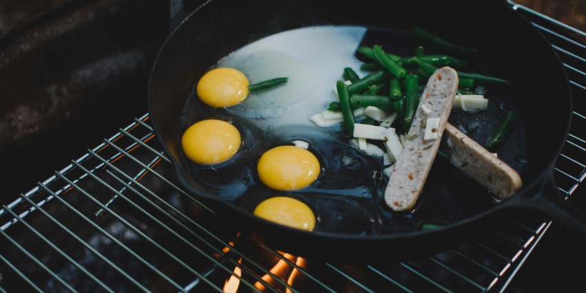 Image of eggs, sausage and beans frying in apan during night camping in Araku Valley