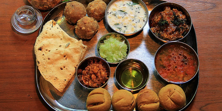 A mouthwatering view of a plate served with Rajasthani delicacies for all to try.