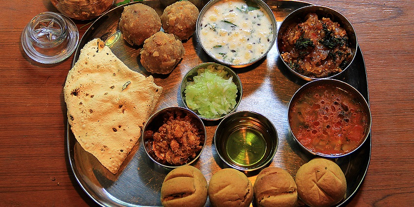 Photo of a traditional Rajasthani plate with different cuisines served for all travellers.