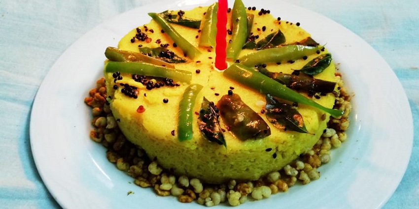 Image of the famous dish of Gujarat is garnished by pouring syrup served on a white plate