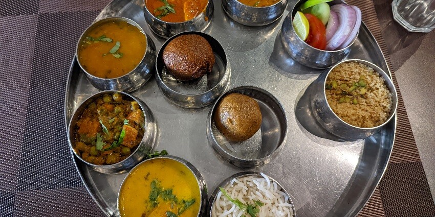 A colorful traditional Rajasthani thali filled with various dishes in Jaipur, Rajasthan.