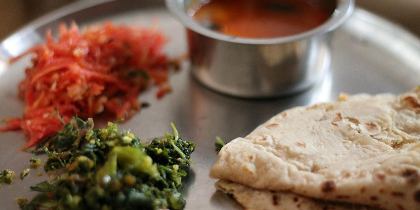 A traditional Rajasthani thali featuring various dishes, near Jagdish Temple, Udaipur.