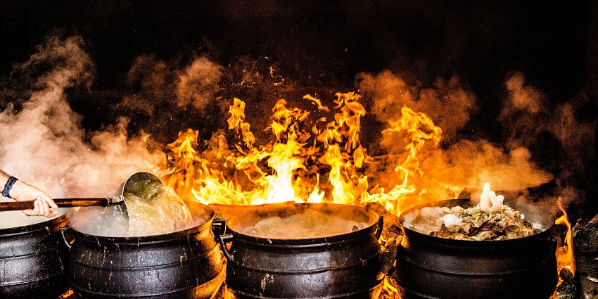 A picture of food being prepared in big vessels at a campsite in Sikkim near the Changey Waterfalls