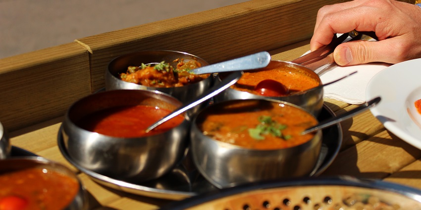 A picture of a full-fledged north Indian meal served on a table at a restaurant near Tughlaqabad Fort