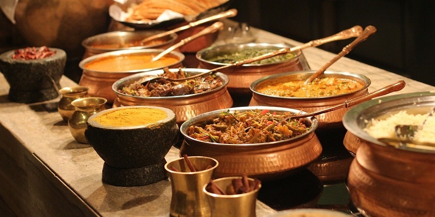 A picture of a buffet of north Indian delicacies served at a restaurant
