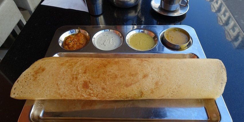 Try masala dosa during your visit to Safdarjung Tomb in Delhi for a culinary experience.