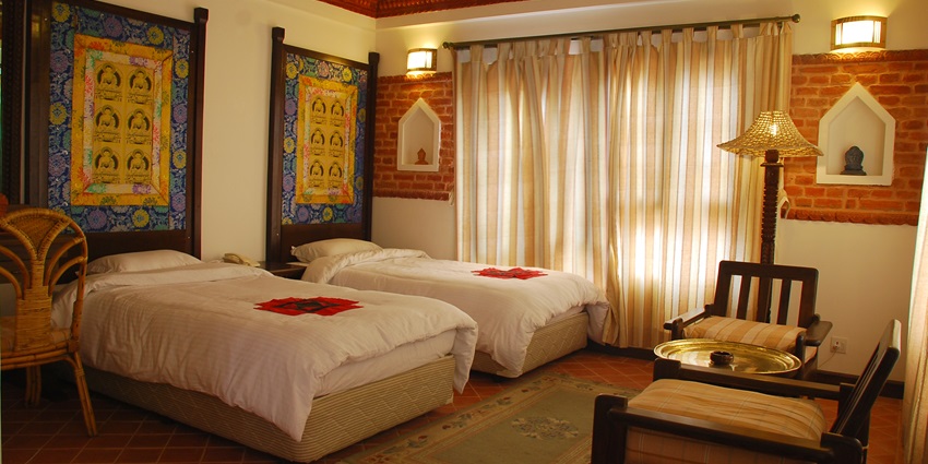 The Manaslu Hotel, charming accommodation in Nepal, surrounded by lush greenery and mountains.