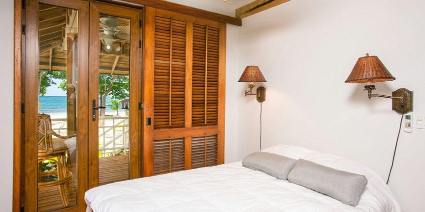 Image of closed wardrobe near on bed in a hotel with amenities and scenic view