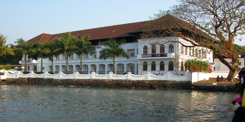 A picture of a hotel near the Dharmatma Waterfall with a river flowing besides