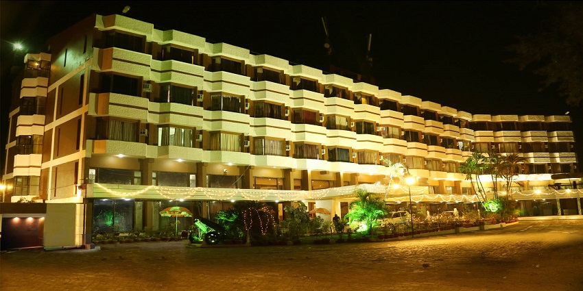 A street view of the Samdareeya Hotel in Jabalpur, India, with its large multi-story facade prominently displayed.