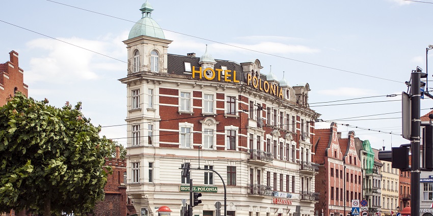 An exterior view of a beautiful hotel taken from across the street, that offers good accommodation.