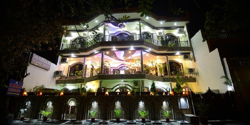 Exterior view of Aman Homestay in Agra, India, featuring a welcoming entrance with a simple, modern design.