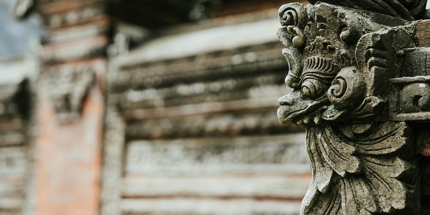 A close up view of the ancient carvings with intricate details on the walls of temples and other monuments.
