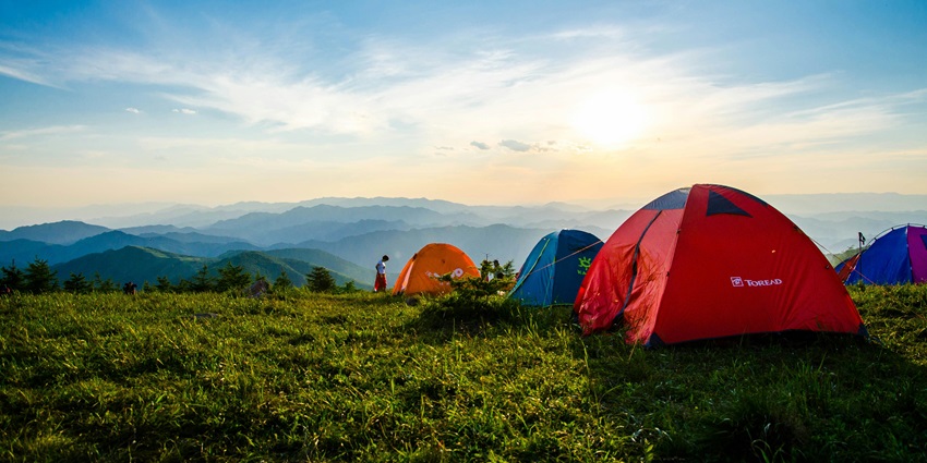 Image of tents on a viewpoint in the wildlife sanctuary surrounded by mountains