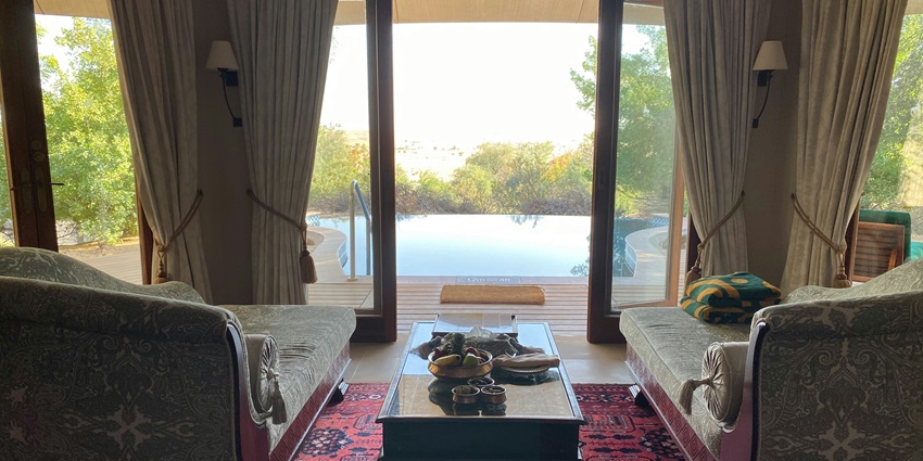 Wide angle shot of a comfortable hotel room to stay with lavish garden in Gujarat
