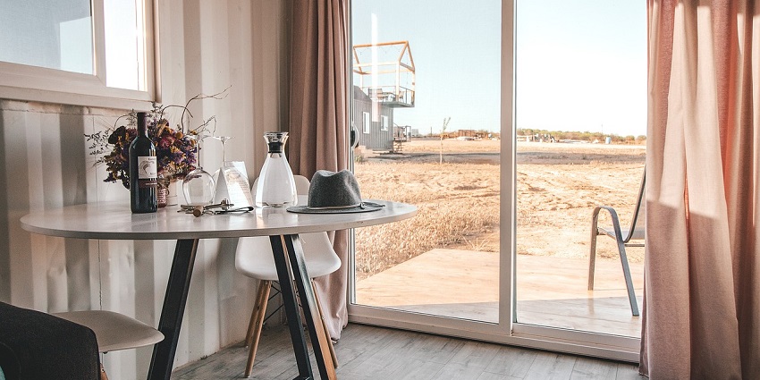Elegant indoor setup with a table, wine glasses, and a cosy vacation ambience.