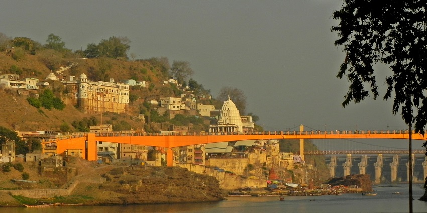View of the famous Omkareshwar Temple, highlighting its traditional architecture and the surrounding river and landscape.