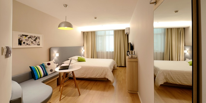 Luxurious hotel bedroom featuring a king-sized bed and chic, contemporary design.