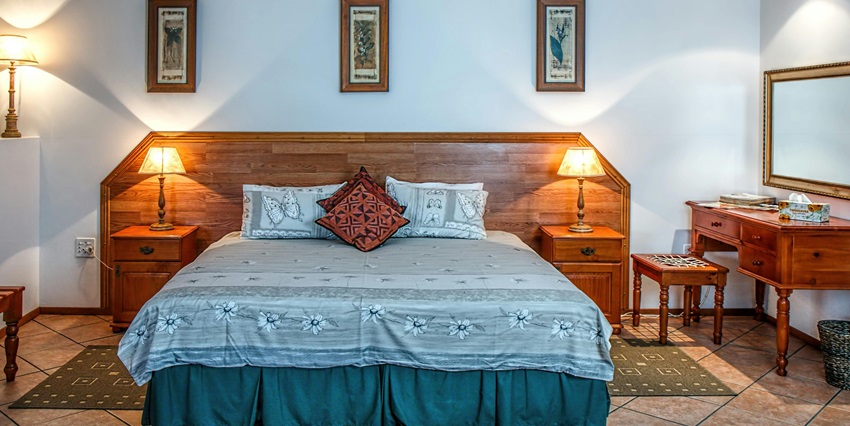 A white bed cover neatly arranged against a wall, creating a cozy atmosphere.