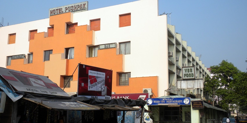 Hotel Pushpak in Bhubaneswar, featuring a modern building with a clean facade and entrance.