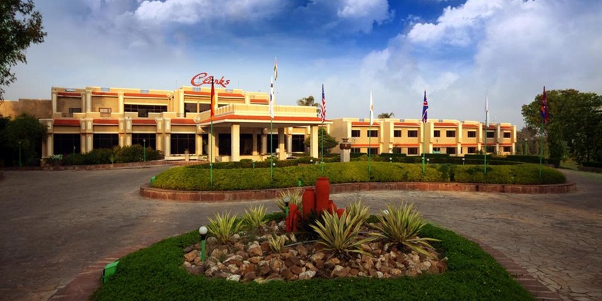 Clarks Khajuraho hotel exterior featuring traditional architecture and lush gardens.