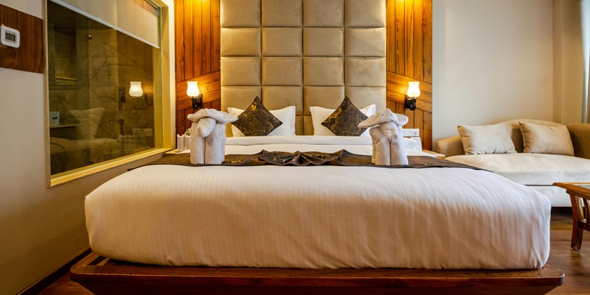 An image showing a hotel room with a cosy bed near one of the accommodations at Ramdevra temple.