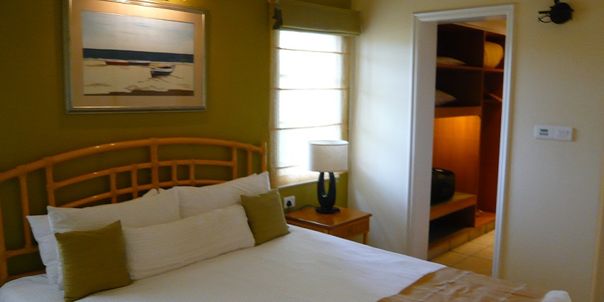 A luxurious resort in Varca, Goa, featuring palm trees and a serene pool area.