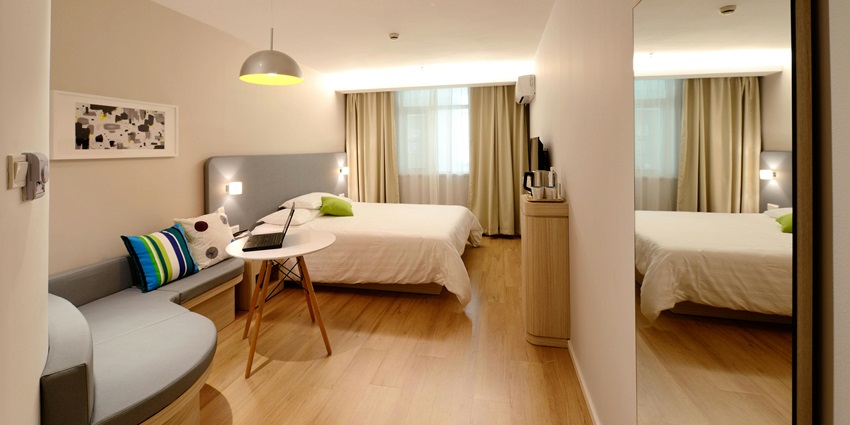 Luxurious hotel room featuring plush bedding and chic decor, offering a relaxing stay