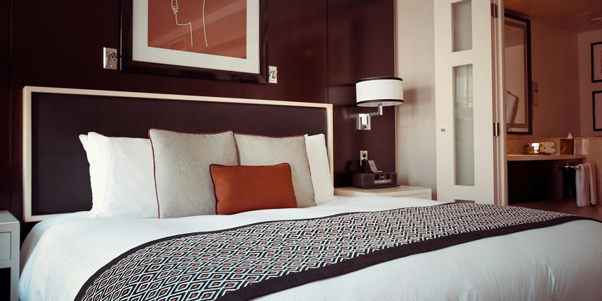 An image of Chic black and grey bedspread elegantly draped over a cosy, inviting bed.