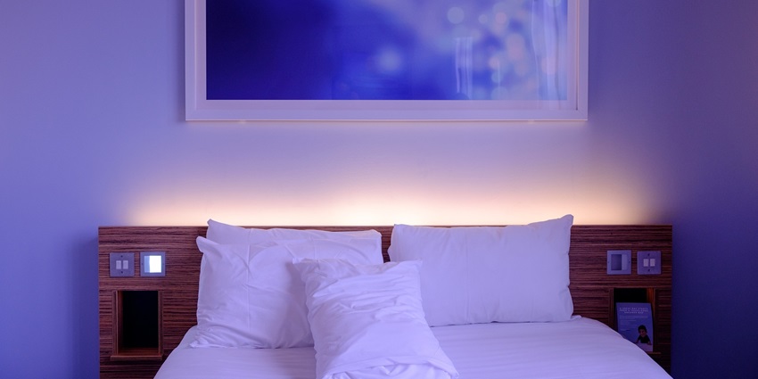 A picture of a bedroom in a hotel with a cosy ambience