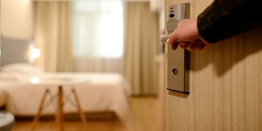 A picture of a person entering their hotel room on a trip to Himachal Pradesh