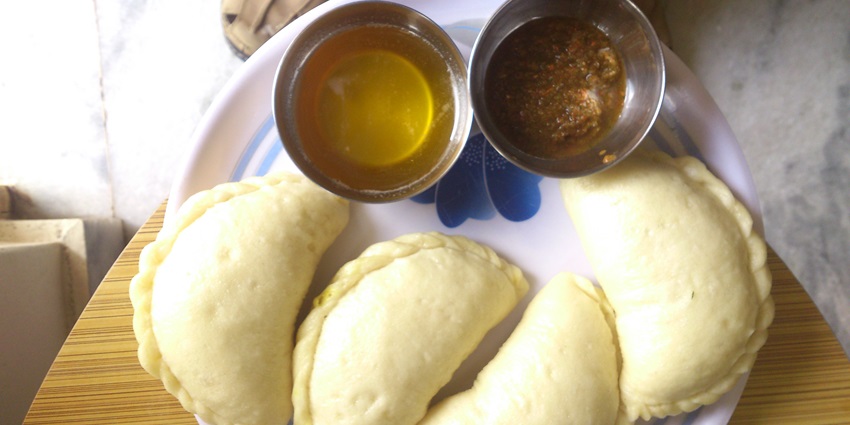 Himachali dish "siduu," traditional steamed bread served with toppings, freshly made.