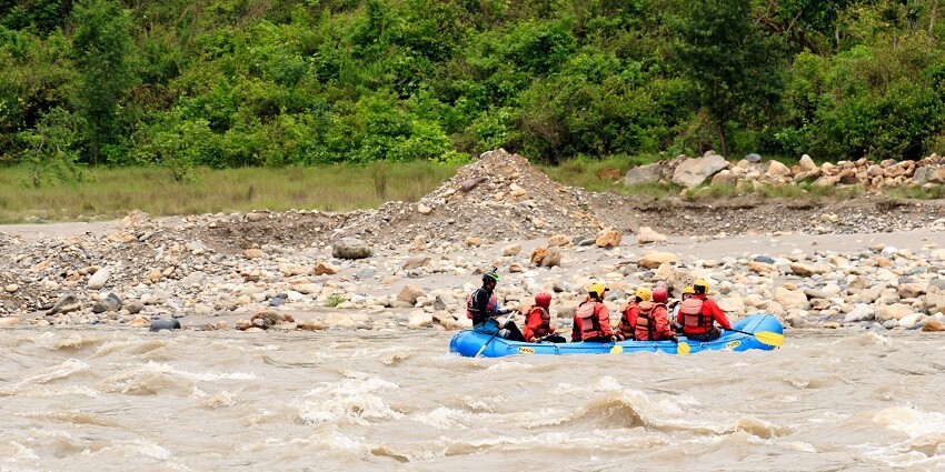 View of tourists rafting in a river, one of the most adventurous things to do in Pokhara