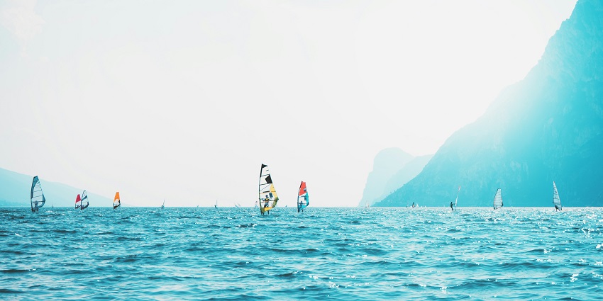 An image of people performing windsurfing, one of the popular water sports in Krabi.
