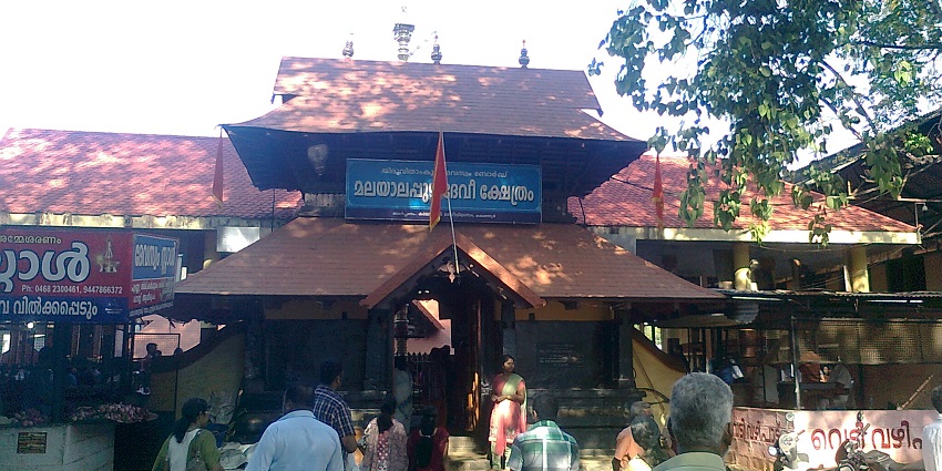 Malayalapuzha Devi Temple's intricate architecture surrounded by lush greenery.