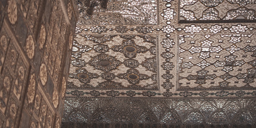 An inside view of Sheesh Mahal featuring intricate mirror-work and beautiful designs.