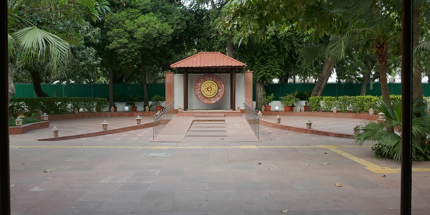 A large gong inscribed with peace symbols, displayed at the National Gandhi Museum.