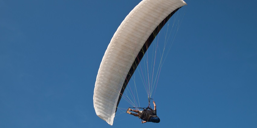 Scenic image of a man gliding in the sky through the parachute in the Skies of Goa