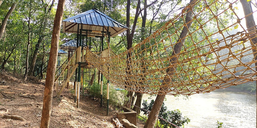 Forest canopy with elevated walkway in an adventure zone at Thenmala Eco Park