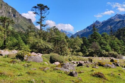 A Valley with mountains on both sides and a lot of rocks and clouds moving above them.