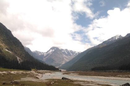 Picturesque view of the Yumthang valley, a stream meandering through the verdant landscapes