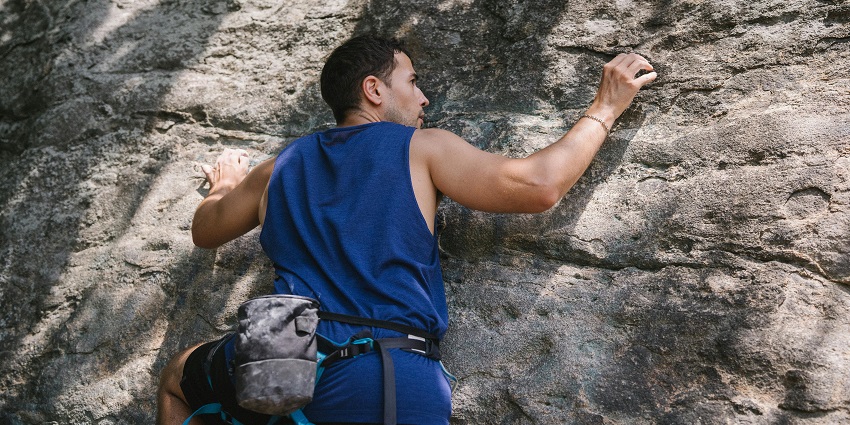 Close up shot of a man rock climbing at the adventure park